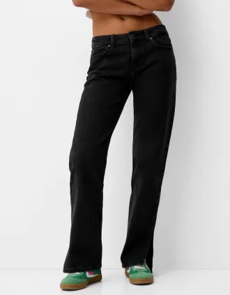 Jeans acampanados con dobladillo dividido Black