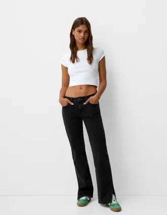 Jeans acampanados con dobladillo dividido Black