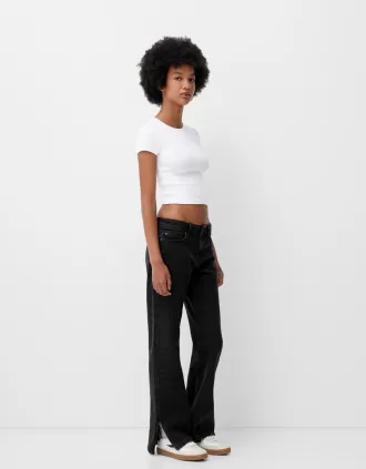 Jeans acampanados con dobladillo dividido Black