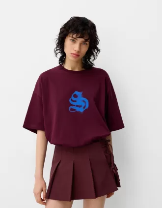 Minifalda con pliegues y detalle de lazo Maroon
