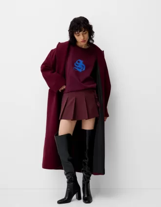 Minifalda con pliegues y detalle de lazo Maroon