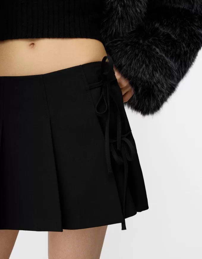 Minifalda con pliegues y detalle de lazo Black