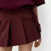 Minifalda con pliegues y detalle de lazo Maroon